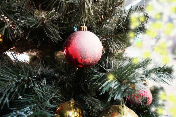 istock christmas tree and small and decoration with many gift box in white, yellow  bokeh 1083539862