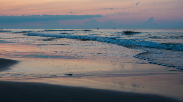 istock waves on the beach at sunrise background 1083543886