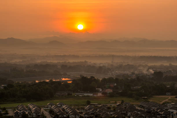 istock colorful sunrise over town with mountain range at background 1083544334