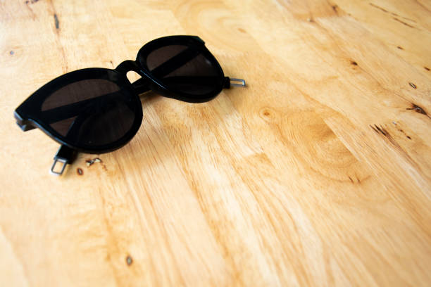istock Black sunglasses on wood table 1083547194