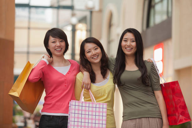 istock Chinese friends shopping together 1083548230