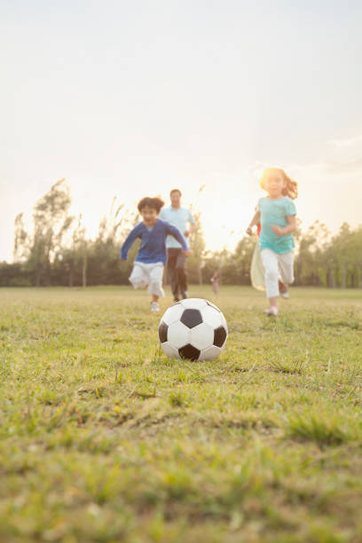 istock Chinese family playing soccer 1083548292