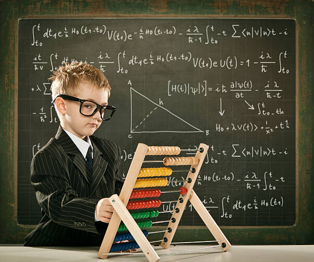 istock genius student or teacher boy with abacus on school blackboard 108354997