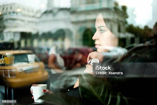 Woman Looking Out A Window In A Cafe At A Street Scene Stock Photo - Download Image Now