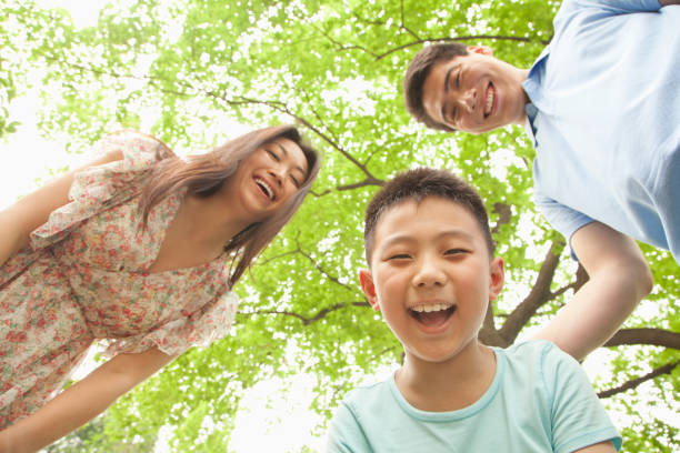 istock Chinese family smiling in park 1083551050