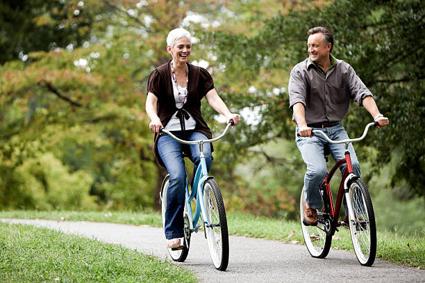 istock Senior Couple Biking Together in the Park 108355403