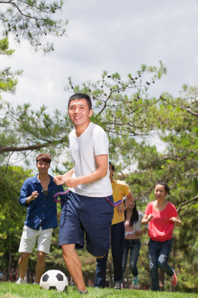 istock Group of Chinese friends playing soccer 1083554782