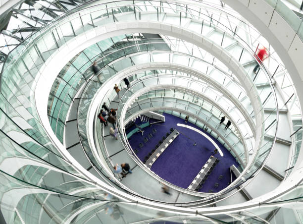 People walking down a spiral staircase in a modern building in London, England.\n\nSee more images from City Hall here:\n[url=file_closeup.php?id=14334056][img]file_thumbview_approve.php?size=1&id=14334056[/img][/url] [url=file_closeup.php?id=14296057][img]file_thumbview_approve.php?size=1&id=14296057[/img][/url] [url=file_closeup.php?id=14272445][img]file_thumbview_approve.php?size=1&id=14272445[/img][/url] [url=file_closeup.php?id=14263437][img]file_thumbview_approve.php?size=1&id=14263437[/img][/url] [url=file_closeup.php?id=14253521][img]file_thumbview_approve.php?size=1&id=14253521[/img][/url] [url=file_closeup.php?id=14327985][img]file_thumbview_approve.php?size=1&id=14327985[/img][/url] [url=file_closeup.php?id=14352092][img]file_thumbview_approve.php?size=1&id=14352092[/img][/url] [url=file_closeup.php?id=14352106][img]file_thumbview_approve.php?size=1&id=14352106[/img][/url] [url=file_closeup.php?id=14620163][img]file_thumbview_approve.php?size=1&id=14620163[/img][/url] [url=file_closeup.php?id=14484859][img]file_thumbview_approve.php?size=1&id=14484859[/img][/url] [url=file_closeup.php?id=14394191][img]file_thumbview_approve.php?size=1&id=14394191[/img][/url]\n\nSee more images of London here:\n[url=/search/lightbox/3723752][IMG]http://i178.photobucket.com/albums/w248/screensaverproduction/londonLB1.jpg[/IMG][/url]\n\nSee more architectural images here:\n[url=/search/lightbox/3649584][IMG]http://i178.photobucket.com/albums/w248/screensaverproduction/architectureLB1.jpg[/IMG][/url]