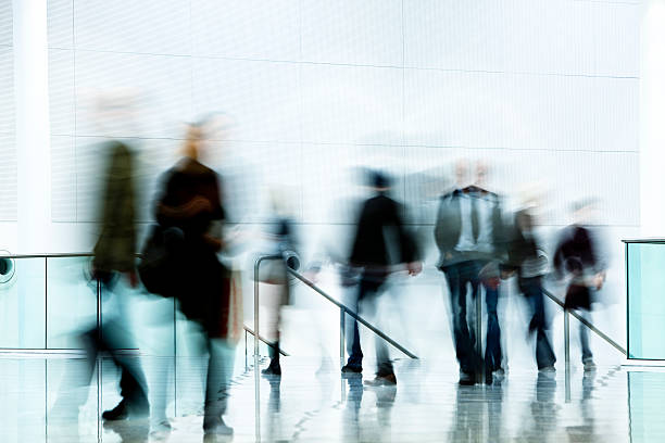 istock Motion Blurred Pedestrians Walking in White Hallway 108355817