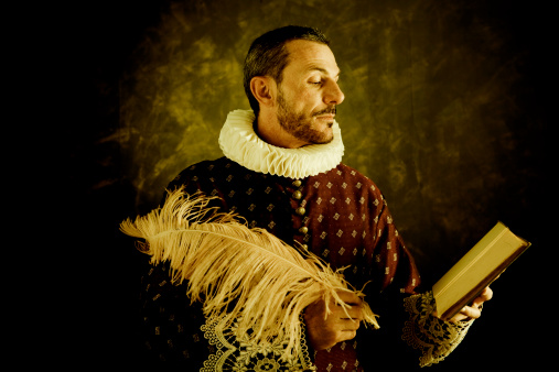 Romantic writer in classic period costume, writing with a feather.