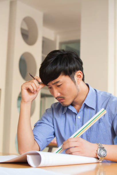 istock Chinese businessman working at desk 1083560398