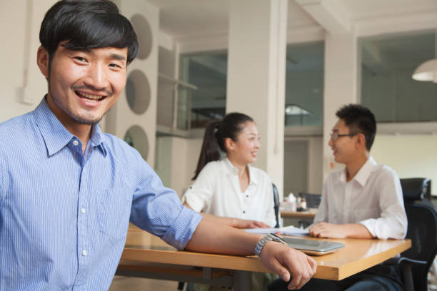 istock Chinese businessman sitting at conference table 1083560498
