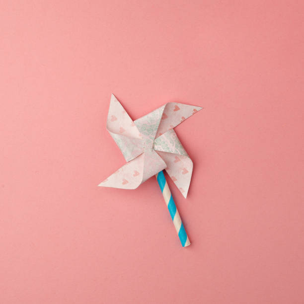 istock Paper windmill on pink background. minimal style 1083562018