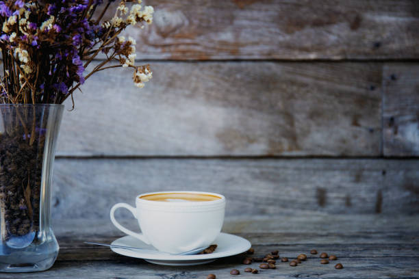 istock Coffee cup and vase on wood. 1083562178