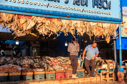 Hurghada, Egypt - December 6, 2018: Sellers and customers at local fish market in Hurghada