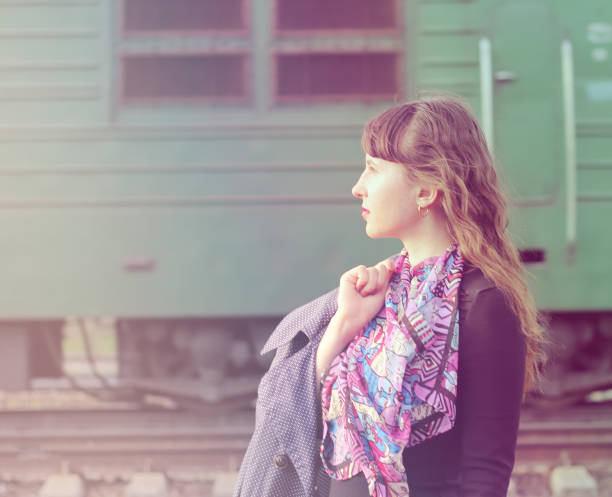 istock Pensive beautiful girl at the train station. 1083564308