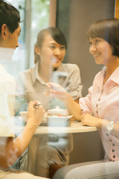istock Chinese friends eating together in cafe 1083564314