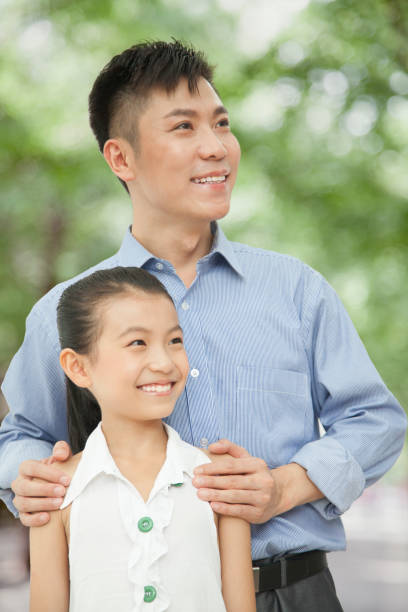 istock Chinese father and daughter smiling 1083565828