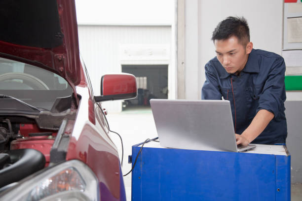 istock Chinese mechanic working on laptop 1083566356