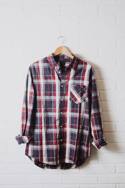 istock Men's shirt on brick wall background 1083569688