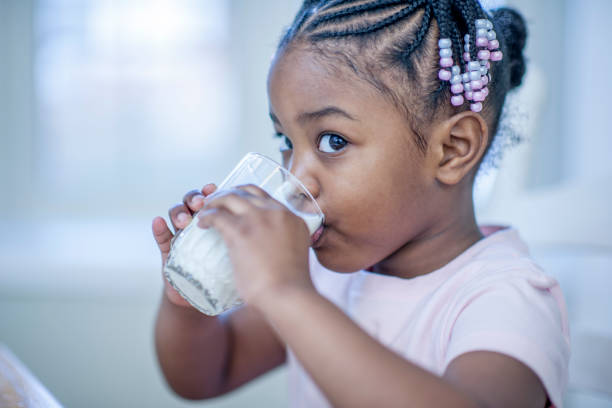 istock Black girl drinking milk 1083569792