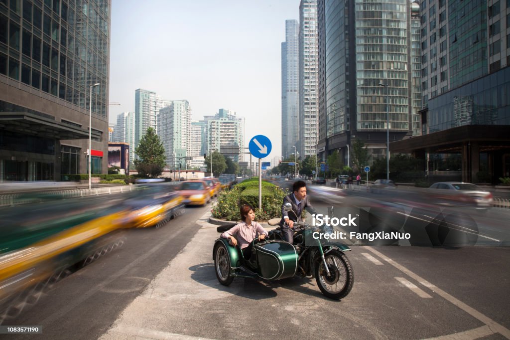 Chinese business people riding motorcycle with sidecar Sidecar Stock Photo