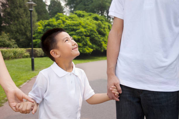 istock Chinese family walking in park 1083572580