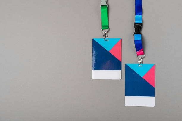 istock Two Colour badges mockup on gray background. Plain empty name tag mock up with colour strings 1083573616