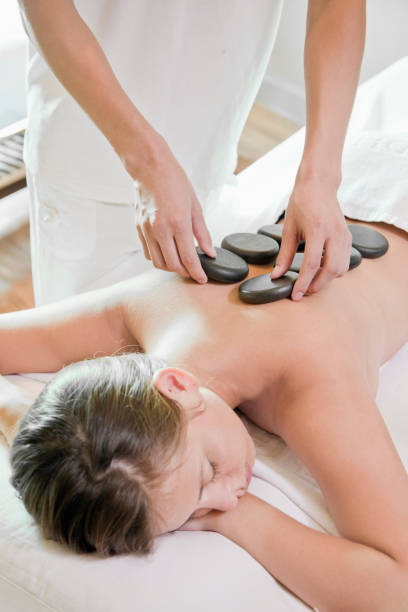 istock Woman having hot stone massage in spa 1083577558