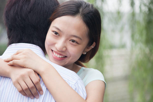 istock Chinese couple hugging in park 1083578170