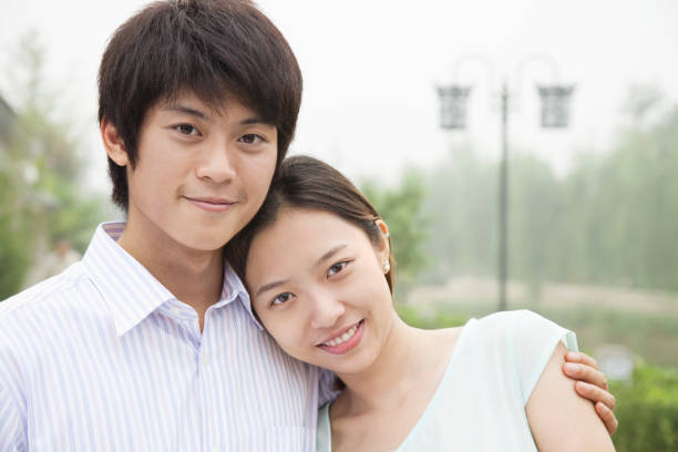 istock Chinese couple hugging in park 1083578192