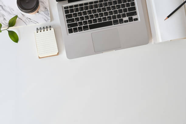 istock Top view workspace hipster with laptop computer, coffee, books and leaf decoration. 1083579524