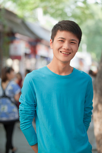 Chinese man smiling outdoors