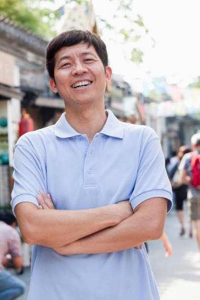 A senior Chinese man against a black background.