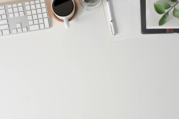 Office desk with top view copy space keyboard computer, coffee, notebook paper and office supply on office desk.