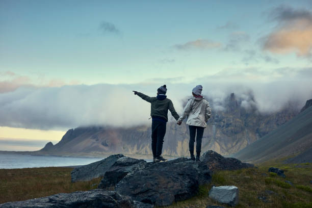 istock Multi ethnic couple on icelandic coast. Admiring the view 1083584180