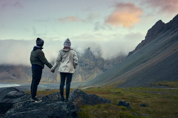istock Multi ethnic couple on icelandic coast. Admiring the view 1083584182