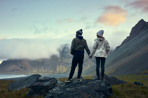 istock Multi ethnic couple on icelandic coast. Admiring the view 1083584212