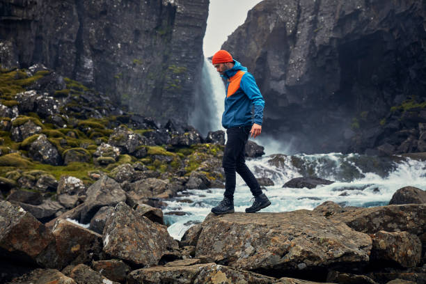 istock Crossing the stream. Mountain landscape 1083584416