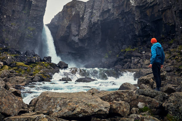 istock Crossing the stream. Mountain landscape 1083584422