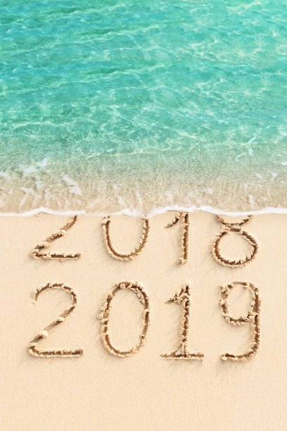 istock New Year concept - 2018 and 2019 handwritten on the beach 1083584634