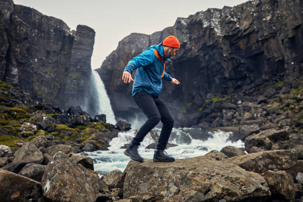 istock Crossing the stream. Mountain landscape 1083584654