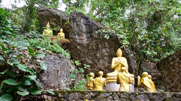 istock Golden Buddhas in Forest, Wat Thammothayalan, Luang Prabang, Laos 1083588094