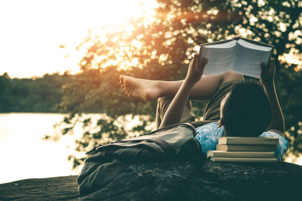 istock Men read books in quiet nature, concept read a books. 1083588384