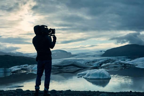 istock Cameraman at glacier lagoon. Sunset 1083589122