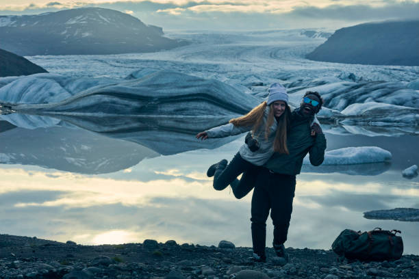 istock Happy multi ethnic couple having fun at glacier lagoon 1083590612
