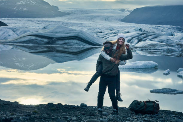 istock Happy multi ethnic couple having fun at glacier lagoon 1083590644