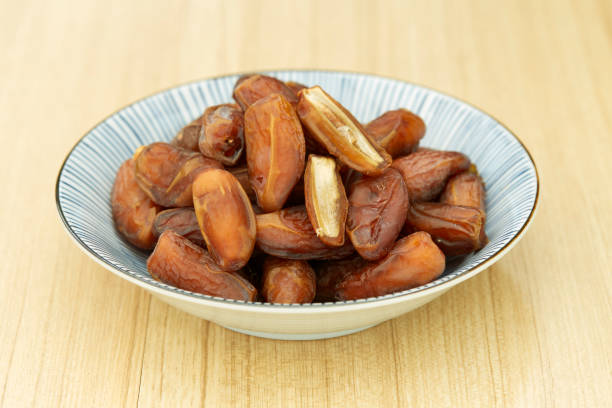 istock Sweet dried dates fruit in a bowl and on the table 1083593190
