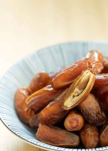 istock Sweet dried dates fruit in a bowl and on the table 1083593222