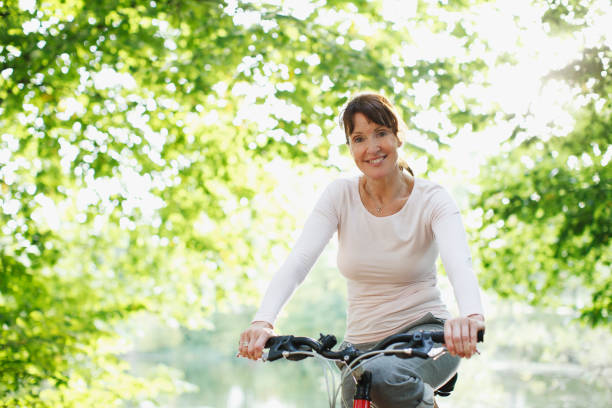 istock Smiling woman riding bicycle 108359464